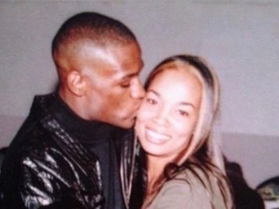 Floyd Mayweather is kissing Josie Harris on her cheek.